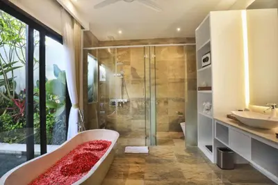 a bathroom with a tub and a shower and a sink at Amara Villa Umalas Bali in Canggu