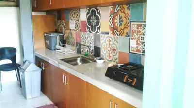 a kitchen counter with a sink and a microwave at Matta Lodge Bali in Jimbaran