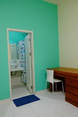 a room with a desk and a sink and a mirror at Matta Lodge Bali in Jimbaran