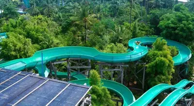 an aerial view of a water slide in the forest at Al-Isha Dharamshala in Kuta