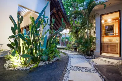 a garden with plants and a walkway next to a building at Villa Chantal-Intimate Villa in Seminyak in Seminyak