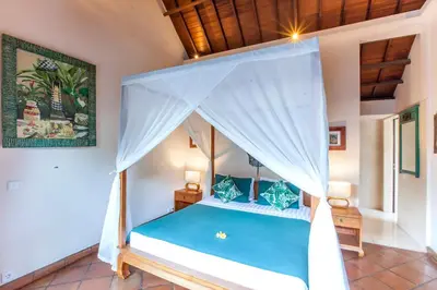 a bedroom with a bed with a canopy at Villa Chantal-Intimate Villa in Seminyak in Seminyak