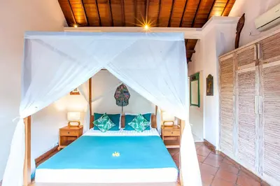 a bedroom with a bed with a canopy at Villa Chantal-Intimate Villa in Seminyak in Seminyak