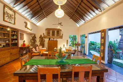 a living room with a wooden table and chairs at Villa Chantal-Intimate Villa in Seminyak in Seminyak
