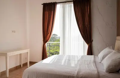 a bedroom with a bed and a large window at Villa with view rooftop in Nusa Dua Bukit in Nusa Dua
