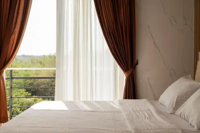 a bedroom with a bed and a large window at Villa with view rooftop in Nusa Dua Bukit in Nusa Dua