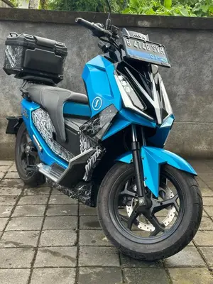 a blue motorcycle parked next to a wall at Villa with view rooftop in Nusa Dua Bukit in Nusa Dua