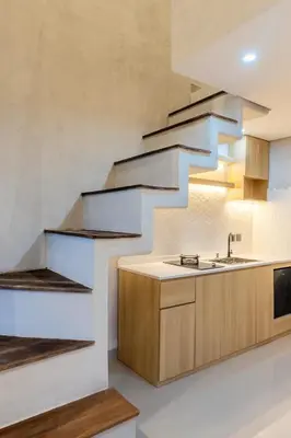 a kitchen with a staircase and a sink at Green Loft Citarum in Sanur