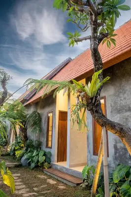 a small house with a tree in front of it at Green Loft Citarum in Sanur