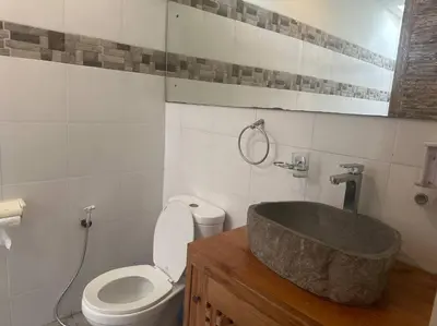 a bathroom with a sink and a toilet and a tub at Villa Catta Seminyak in Legian