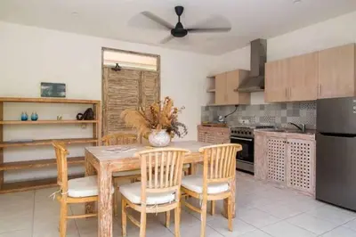 a kitchen with a wooden table and chairs at Villa Catta Seminyak in Legian