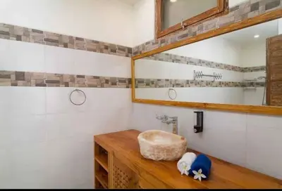 a bathroom with a sink and a mirror at Villa Catta Seminyak in Legian