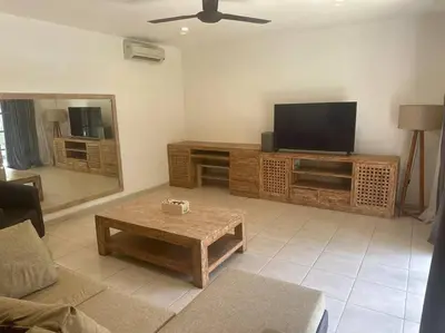 a living room with a television and a coffee table at Villa Catta Seminyak in Legian