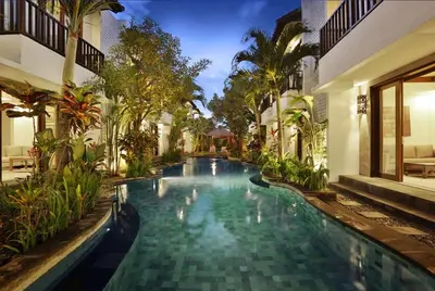 a swimming pool in the middle of a building at Seminyak Apartment by LBV in Seminyak