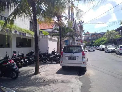 a white car parked on the side of a street at Seminyak Apartment by LBV in Seminyak