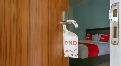 a bedroom with a door with a dnd sign on it at OYO 1755 De'balcon Accomodation Near Ngurah Rai Airport in Ngurah Rai International Airport