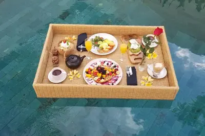 a tray of food on a table in the water at Sol Bella Villa 3 in Seminyak