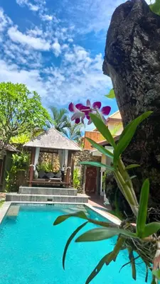 a villa with a swimming pool and a house at ViLLA GREEN MANGGO III in Seminyak