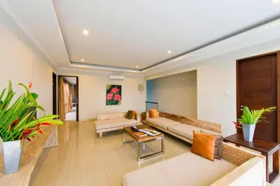 a living room with two couches and a table at Divija 2 BR Private Pool Villa in Seminyak