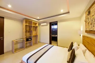 a bedroom with a large white bed in a room at Divija 2 BR Private Pool Villa in Seminyak