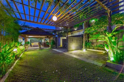 an indoor garden with a pergola and plants at Divija 2 BR Private Pool Villa in Seminyak