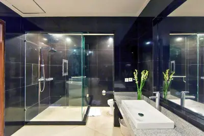 a bathroom with a shower and a toilet and a sink at Divija 2 BR Private Pool Villa in Seminyak