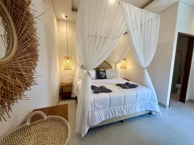 a bedroom with a canopy bed with white curtains at Villa NANEE - Legian - 5 Bedroom - 5 Bathroom in Legian