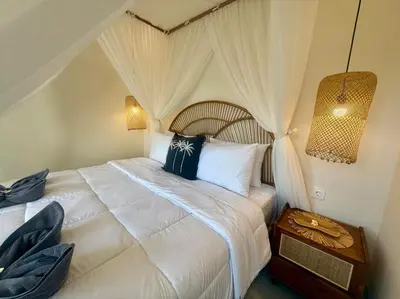a bedroom with a large white bed with a canopy at Villa NANEE - Legian - 5 Bedroom - 5 Bathroom in Legian