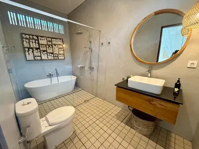 a bathroom with a toilet and a sink and a mirror at Villa NANEE - Legian - 5 Bedroom - 5 Bathroom in Legian