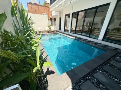 a swimming pool on the side of a house at Villa NANEE - Legian - 5 Bedroom - 5 Bathroom in Legian