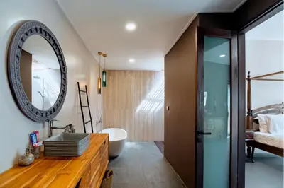 a bathroom with a sink and a mirror on the wall at Villa Damira in Seminyak