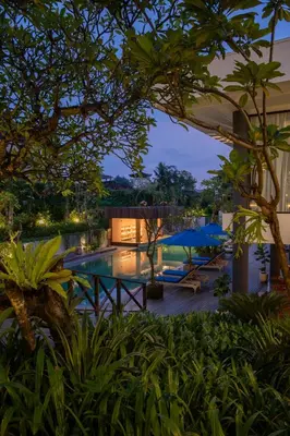 a view of a resort with a pool at night at Dialoog Seminyak in Seminyak