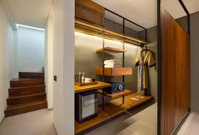 a room with a walk in closet with a microwave at Dialoog Seminyak in Seminyak