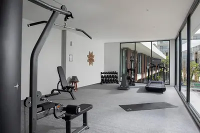 a gym with cardio equipment in a building at Dialoog Seminyak in Seminyak