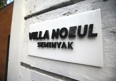 a sign on the side of a building at Villa Noeul Seminyak - Fast Wifi And Private Pool in Seminyak