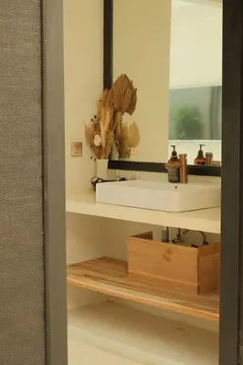 a bathroom with a white sink and a mirror at Villa Malicott Athena - 3C in Seminyak