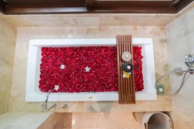 a bathroom with a wall of red glitter at Akhira One Seminyak in Seminyak