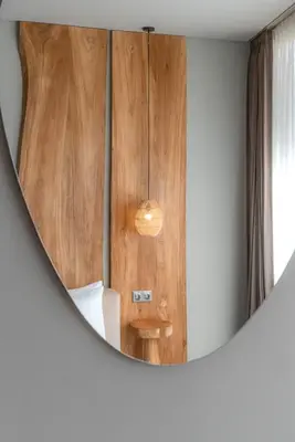 a mirror in a room with a wooden wall at Villa Amanora & Amaluna - 2 Stunning Villas, 9 Bedrooms for Groups in Canggu