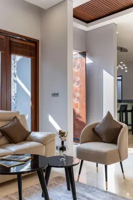 a living room with two chairs and a coffee table at Rumah Impian Villa by Betterplace in Canggu