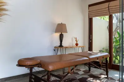 a living room with a bench and a table at Rumah Impian Villa by Betterplace in Canggu
