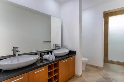 a bathroom with two sinks and a mirror at Rumah Impian Villa by Betterplace in Canggu