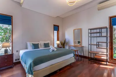 a bedroom with a large bed in a room at Rumah Impian Villa by Betterplace in Canggu
