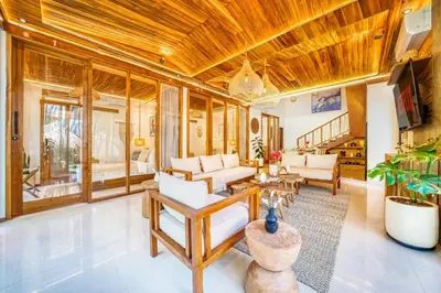 a living room with wooden ceilings and white furniture at Villa Chicago Brand new 7 BDR private pool in Seminyak
