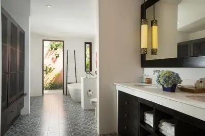 a bathroom with a tub and a toilet and a sink at Villa Mamoune in Umalas