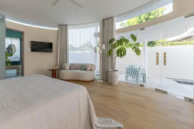 a large white bedroom with a bed and a couch at Uniquely designed 1bd villa with Pvt Pool in Umalas
