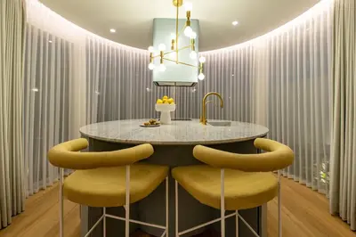 a kitchen with a round table and yellow chairs at Uniquely designed 1bd villa with Pvt Pool in Umalas