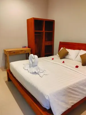a bedroom with a bed with a swan towel on it at De Jaya in Kerobokan