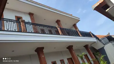 a white building with a balcony on it at De Jaya in Kerobokan