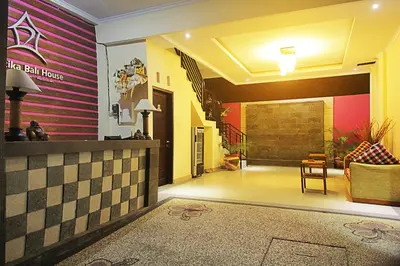 a lobby of a hotel with pink and yellow walls at Ramantika Bali House in Jimbaran