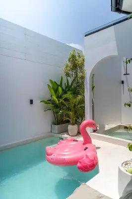 a pink inflatable pink flamingo in a swimming pool at Villa Adela 1 Berawa 3BR Villa Near Atlas, Finns Beach Clubs in Canggu